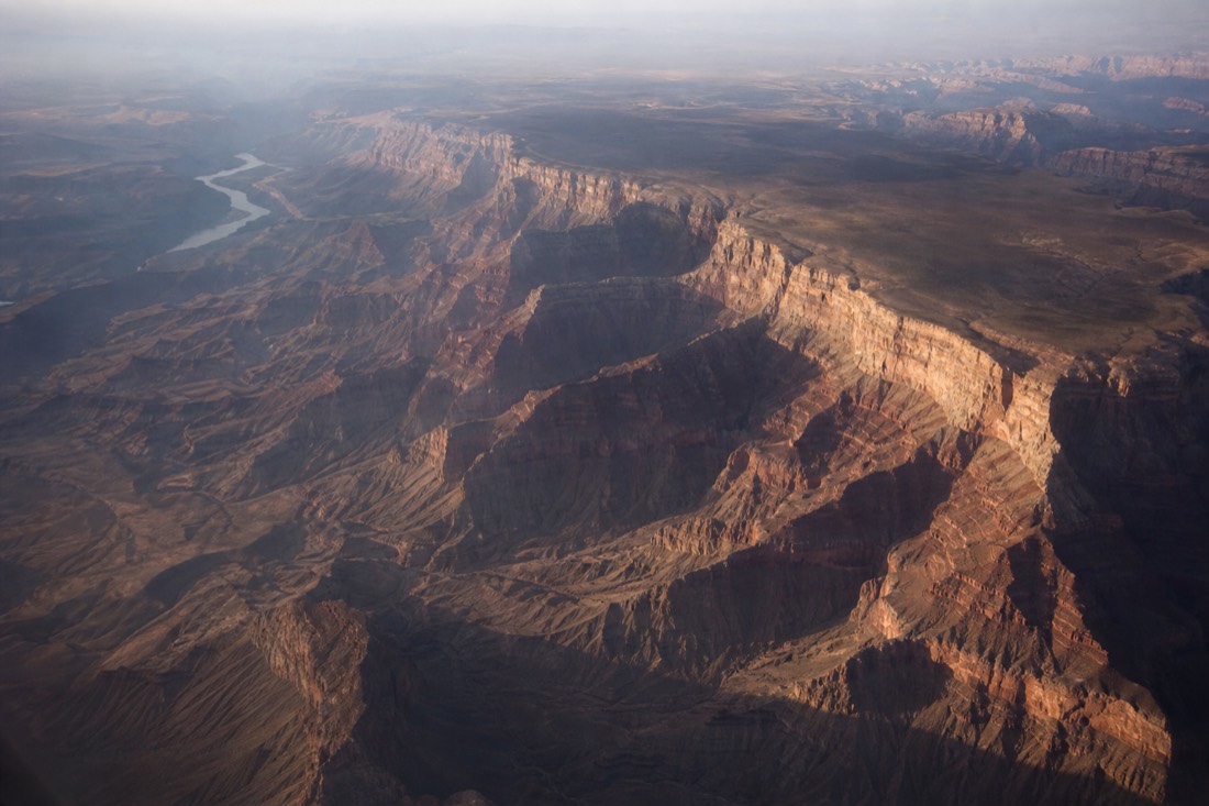 The vast layered expanse of the Grand Canyon seen wide from a high airplane window